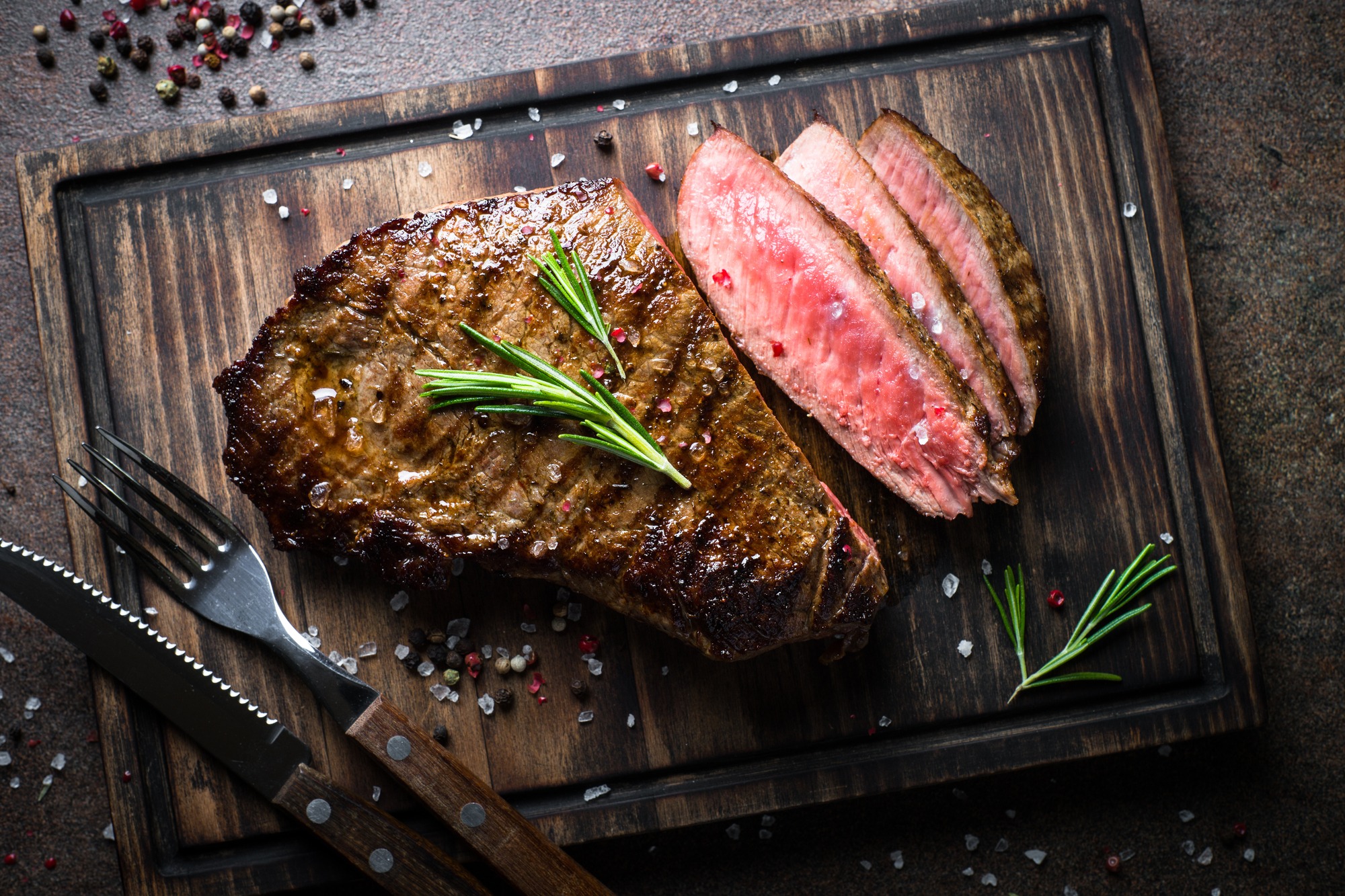 Fresh Grilled Meat. Grilled Beef Steak Medium Rare on Wooden Cutting Board.